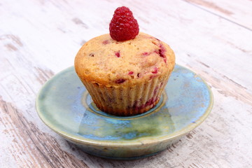 Fresh baked cupcake with raspberries, delicious dessert