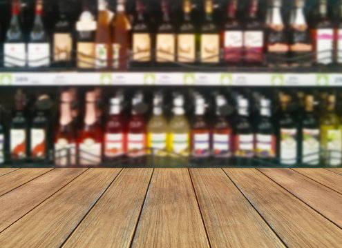 wood floor and wine Liquor bottle on shelf - Blurred background