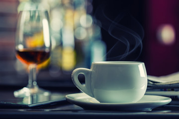 Fototapeta premium Coffee and drink. Cup of Coffee and Cognac Brandy Whiskey Aperitif in modern night bar