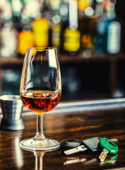 Alcoholism. Cup cognac hand man the keys to the car and irresponsible driver.