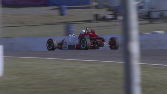 Formula car drives on a circuit track.