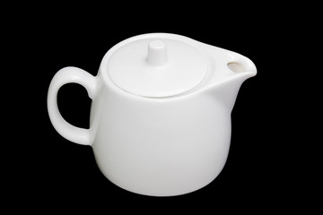 White teapot on a black background
