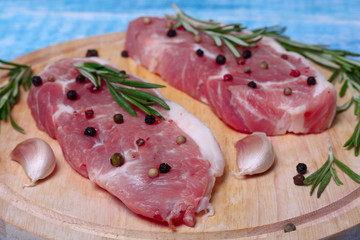 fresh raw meat with rosemary and pepper
