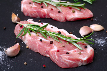 fresh raw meat with rosemary and pepper
