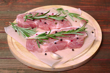 fresh raw meat with rosemary and pepper