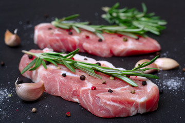fresh raw meat with rosemary and pepper