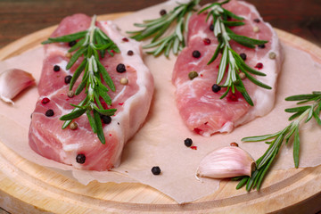 fresh raw meat with rosemary and pepper