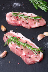 fresh raw meat with rosemary and pepper
