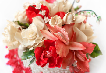 Wedding cake with red flowers.