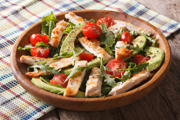 Dietary chicken salad with avocado, arugula and cherry tomatoes