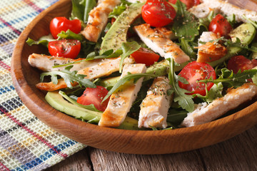 Homemade chicken salad with avocado and arugula closeup. horizontal
