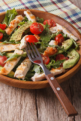 Chicken salad with avocado, arugula and tomato closeup. Vertical
