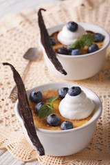 Creme brulee dessert with berries close-up on the table. Vertical
