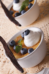 Vanilla Creme brulee dessert with blueberries close-up. Vertical
