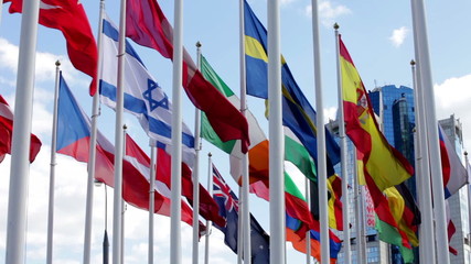 Flags of different countries flapping in wind