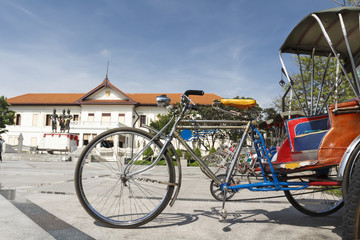 Vintage tricycle bicycle at three king monument in Chiang mai .