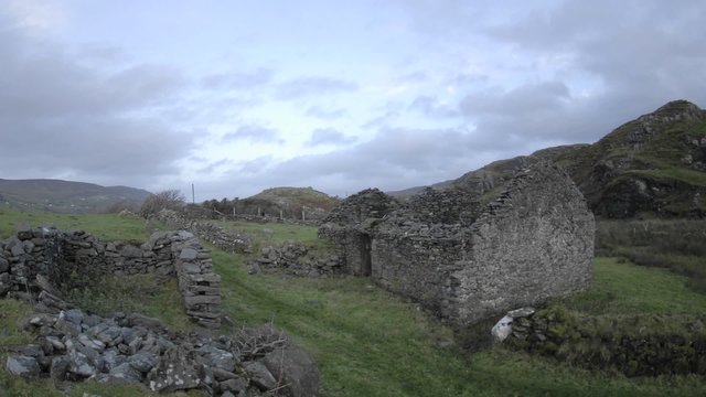 Panning time lapse of clouds blowing over the ruins in Glencolumbkille, County Donegal, Ireland.