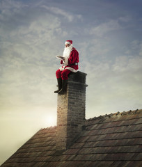 Santa Claus sitting on the chimney