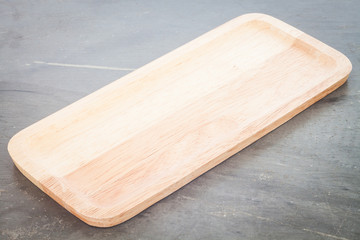 Wooden plate on grey background