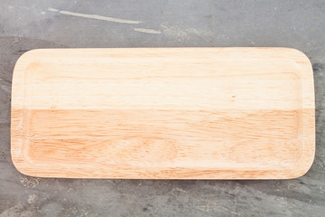 Wooden plate on grey background
