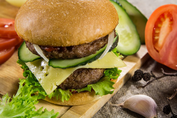 Beef burger with cheese and vegetables