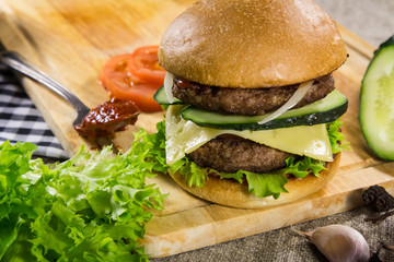 Beef burger with cheese and vegetables