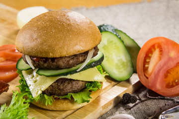 Beef burger with cheese and vegetables