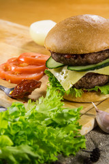 Beef burger with cheese and vegetables