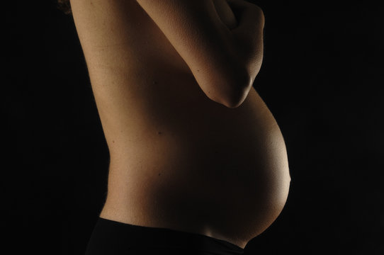 pregnant woman with black background