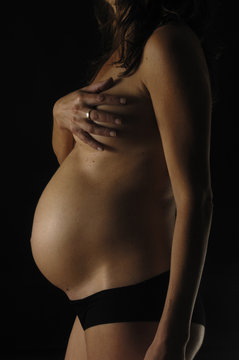 pregnant woman with black background, silhouette
