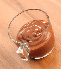 cup of liquid chocolate on dark wooden table
