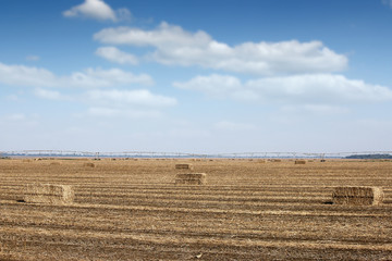 straw bale and center pivot sprinkler system on field