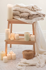 Natural small wooden ladder on white wood floor with warm wool s