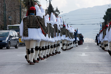 Evzones infantry, goose-stepping on Vassilisis Sofias avenue, Kolonaki, following the maching band,...