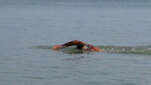 Muscular swimmer in the lake