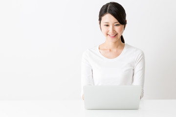 attractive asian woman using laptop