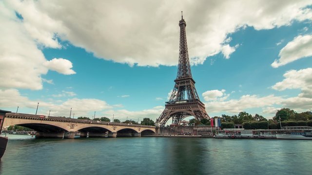 Eiffel Tower by The Seine River & Boats 2, Paris - Time Lapse: A timelapse of the Eiffel Tower along the river Seine with flyboats (bateaux mouches) passing by with motion blu.
