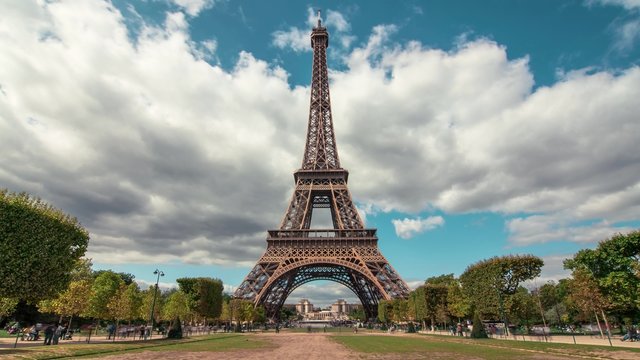 Eiffel Tower & Champ de Mars, Paris - Time Lapse: A timelapse of the the Eiffel Tower from the Champ de Mars by a sunny evening. Tourists are passing by with motion blur. 20 minutes Time Lapse.