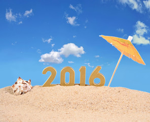 2016 year golden figures on a beach sand