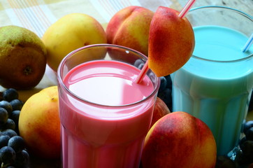 Two fresh fruit smoothies on white background