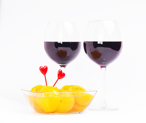 Red wine valentine glasses with peaches