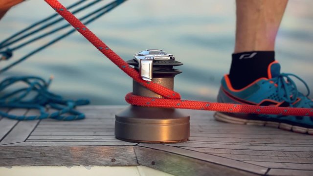 Ships boy knotting  rope on a boat