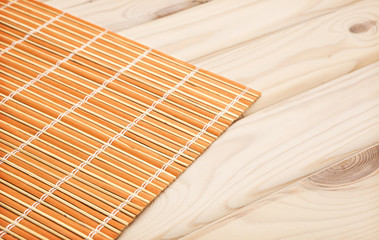 Sushi background. bamboo napkin on wooden background