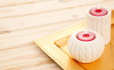 lovely lit candle on light wooden table
