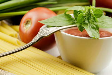Tomato sauce with fresh basil leaves and tomatoes
