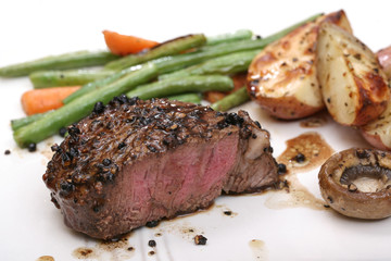 Filet dinner on plate with potatoes, green beans and mushrooms