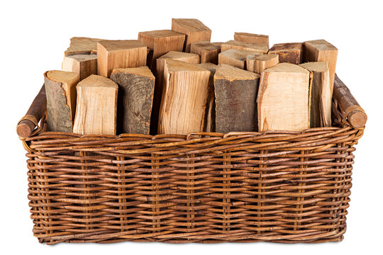fire wood in basket isolated on white background