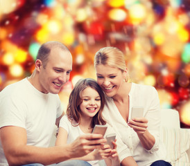 happy family with smartphones