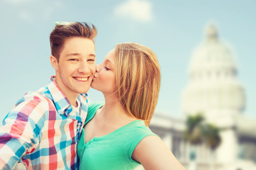 Fototapeta premium couple kissing and taking selfie over white house