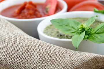 Pesto and tomato sauce with fresh basil leaves and tomatoes
